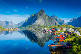 Perfect reflection of the Reine village on the water of the fjord in the Lofoten Islands,  Norway