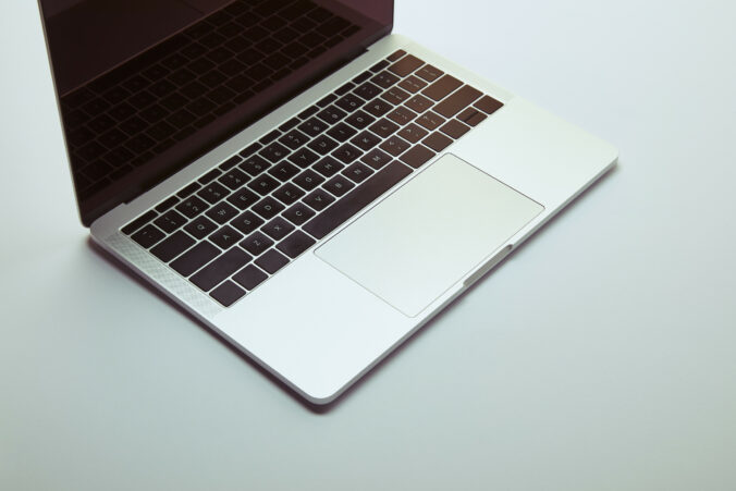 Laptop with blank screen on white tabletop