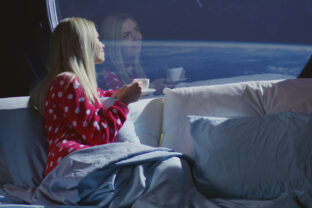 Woman enjoying view and coffee in a spaceship