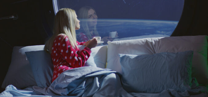 Woman enjoying view and coffee in a spaceship