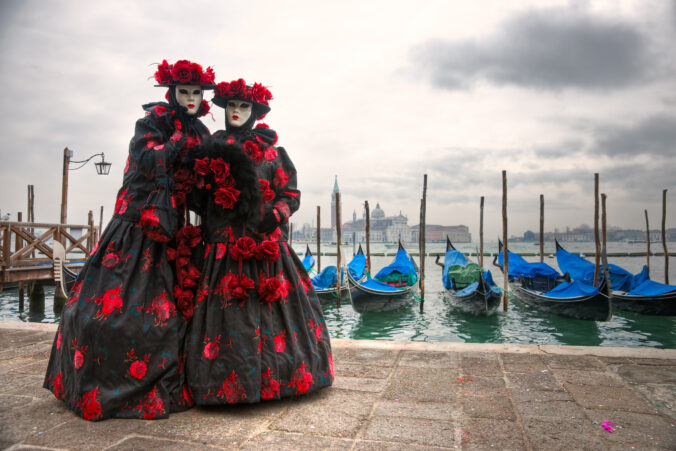 Two venetian masks in San marco's square. Venice Italy..