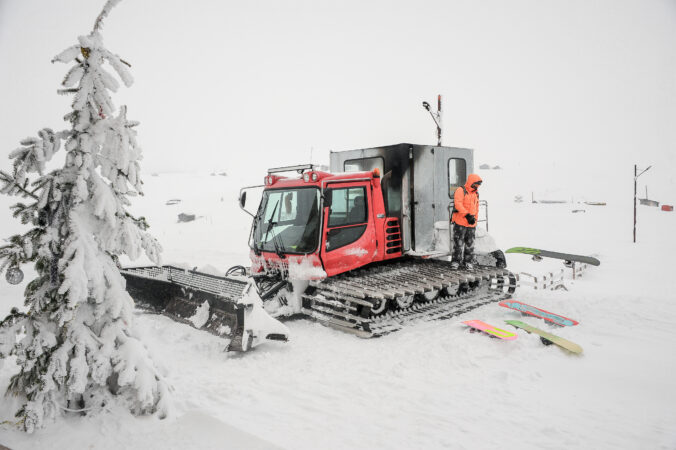 Snowboarder standing on the snow plough in Goderdzi, Georgia