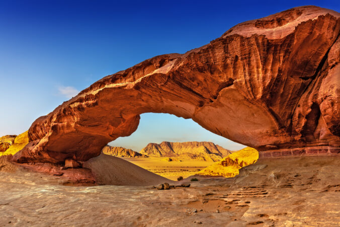 View through a rock arch in desert of Wadi Rum