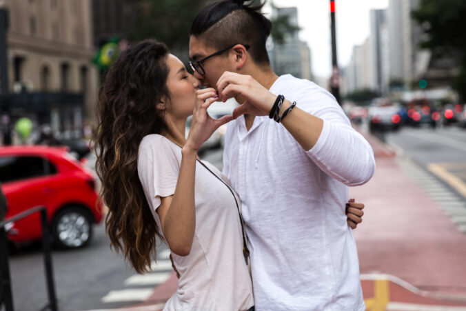 Young Asian Couple Making a Heart Shape with Their Hands