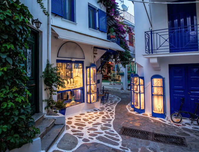 Beautiful old, narrow alley with cobblestone in Skiathos, Greece