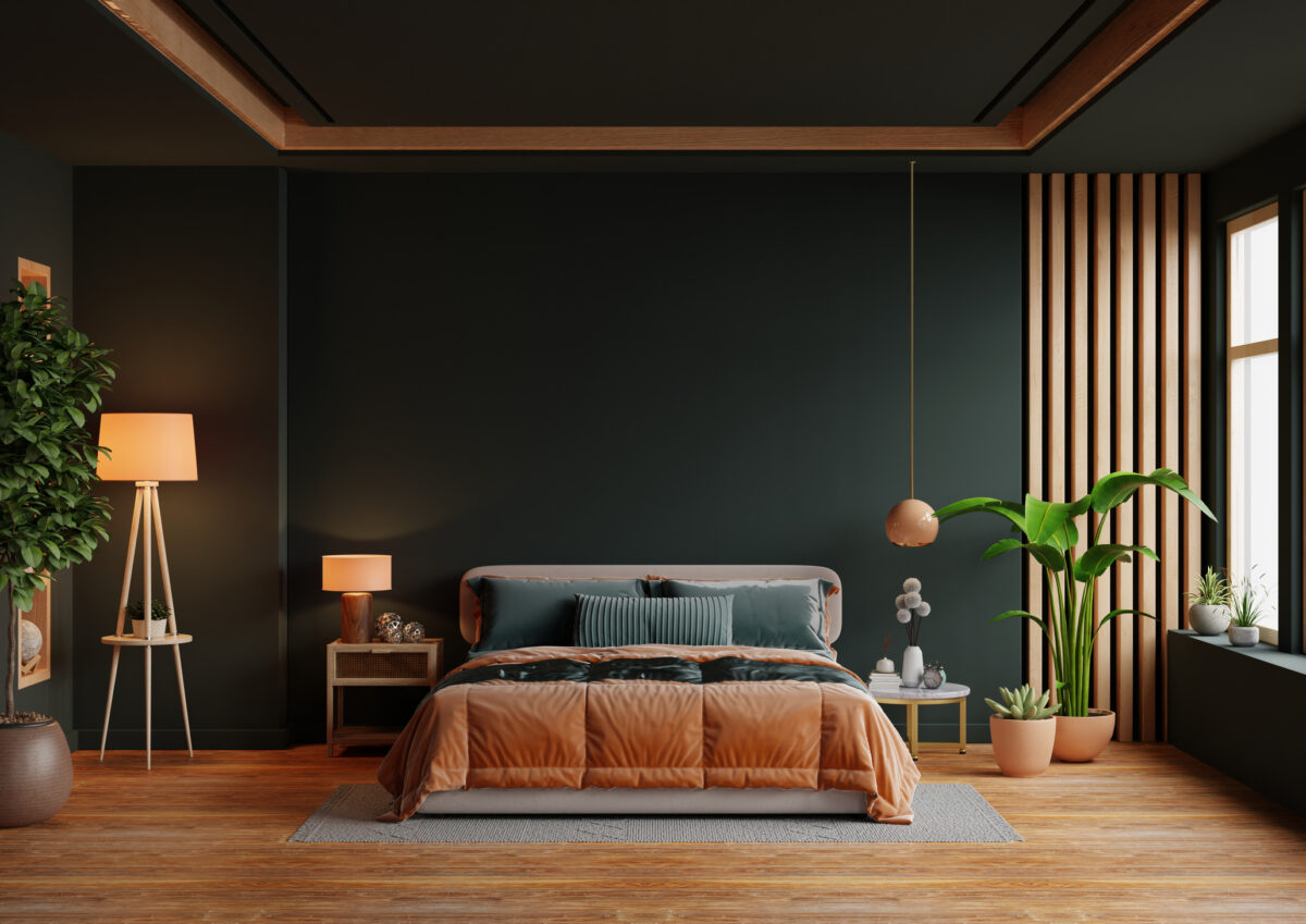 Orange bed and mockup dark green wall in bedroom interior 3D rendering
