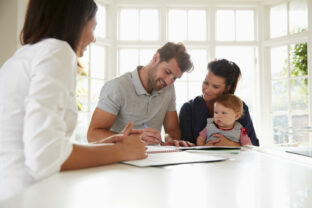 Family With Baby Meeting Financial Advisor At Home