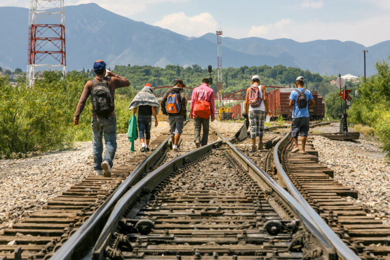A group of migrants walk along the railroad near the US Mexico border in the state of Coahuila in northern Mexico