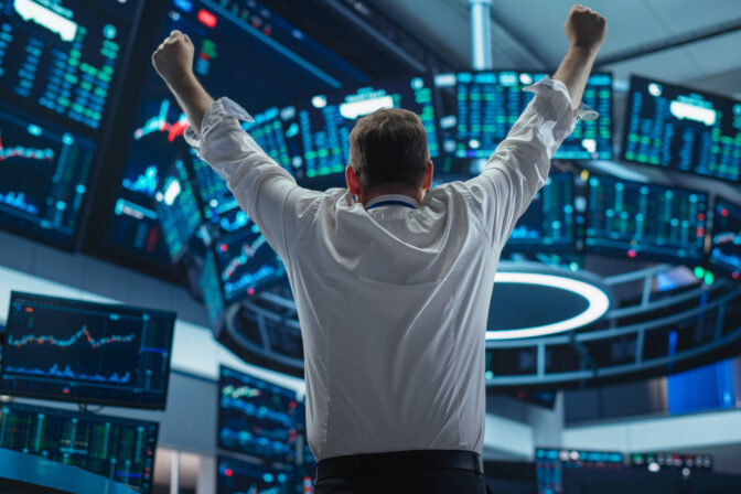 Excited Businessman Raises Hands and Punches Air while Celebrating Successful Deal. Stock Exchange Manager Happy After Investment Day. Broker in White Shirt Wins a Profitable Contract. Back View