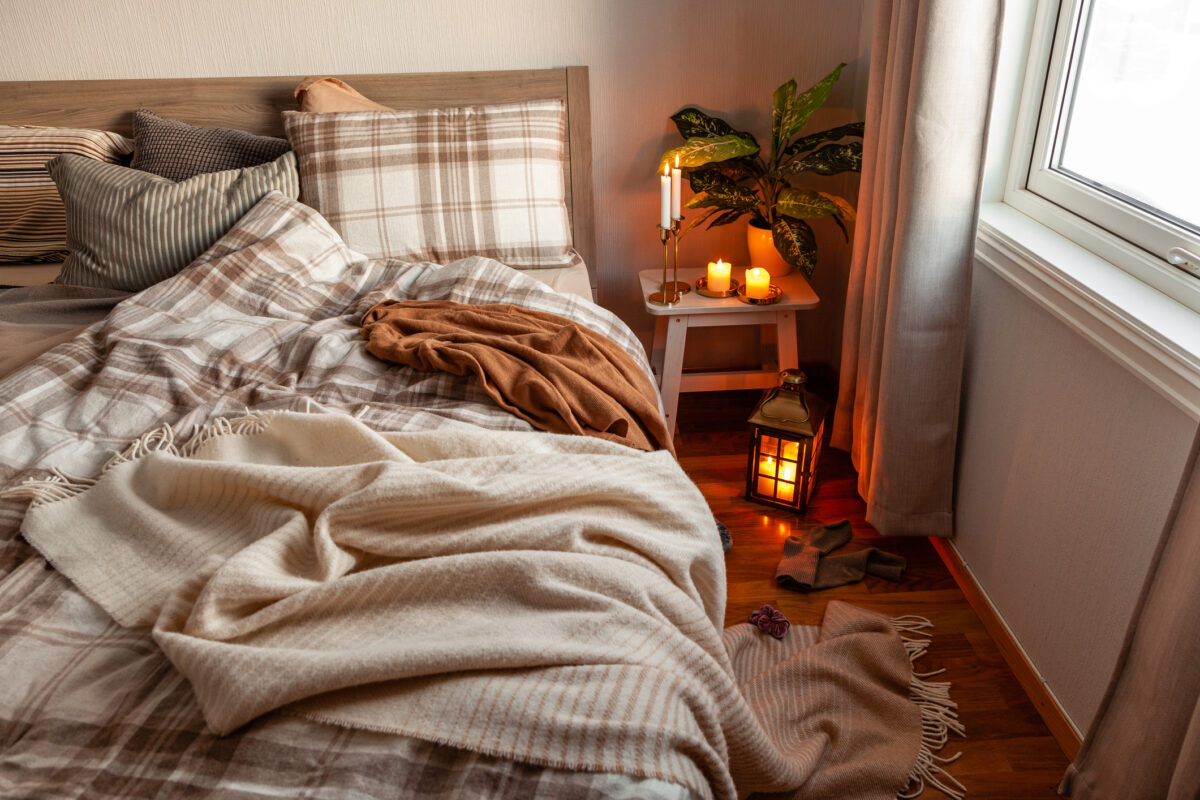 Cozy scandinavian bedroom interior in natural tones, real life mess disorder