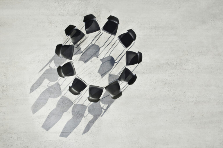 Circle of office chairs on sidewalk