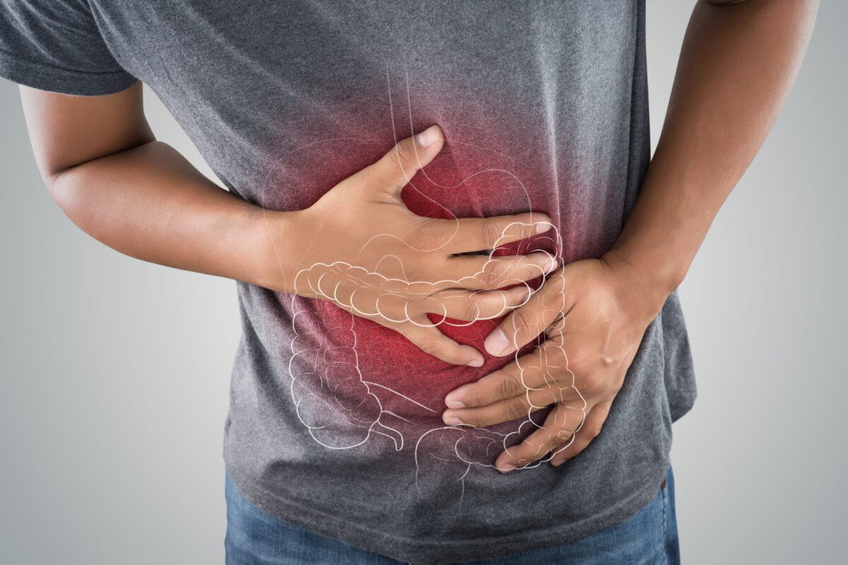 The photo of large intestine is on the man&#039;s body against gray background, People With Stomach ache problem concept, Male anatomy
