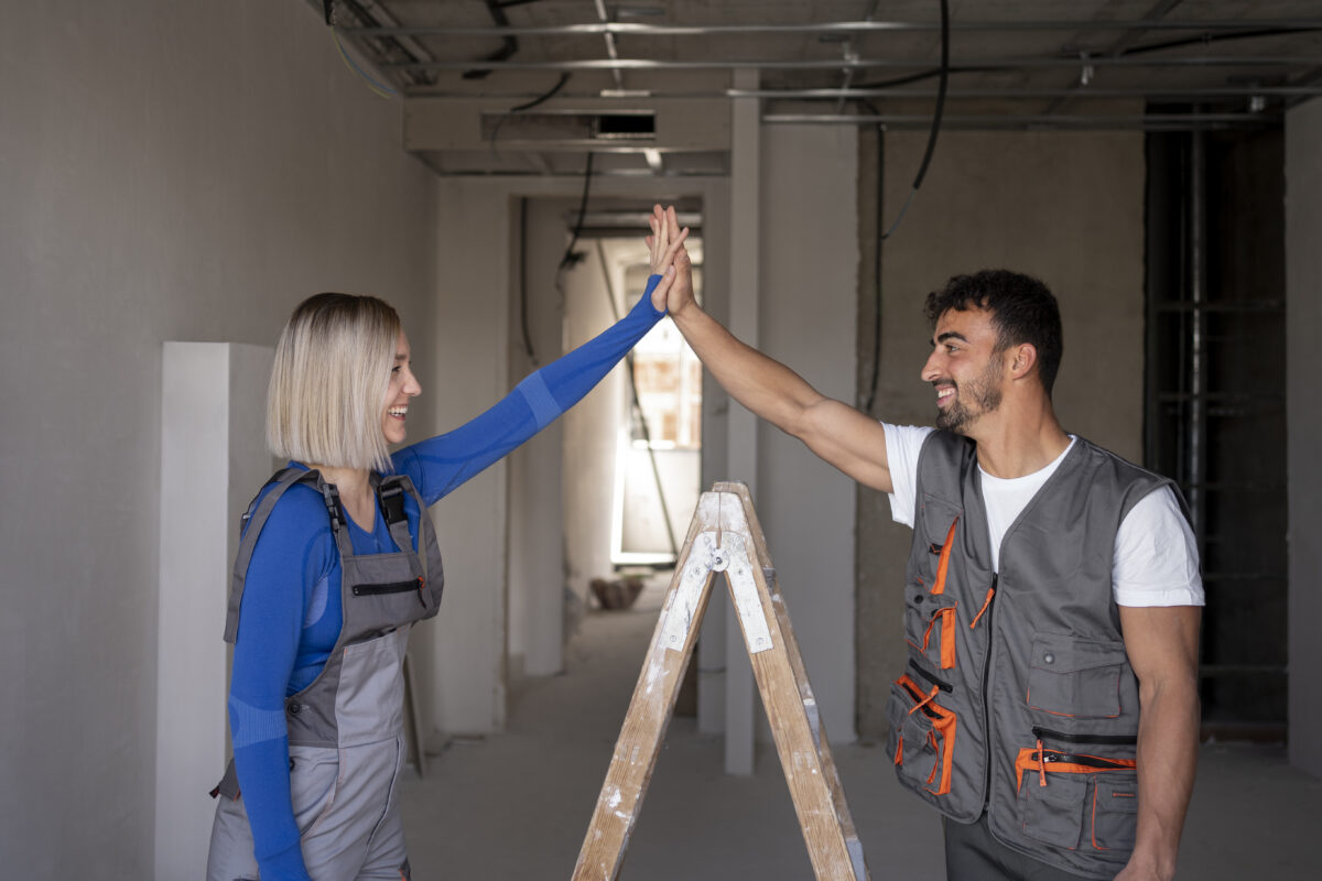 Medium shot workers high five.jpg