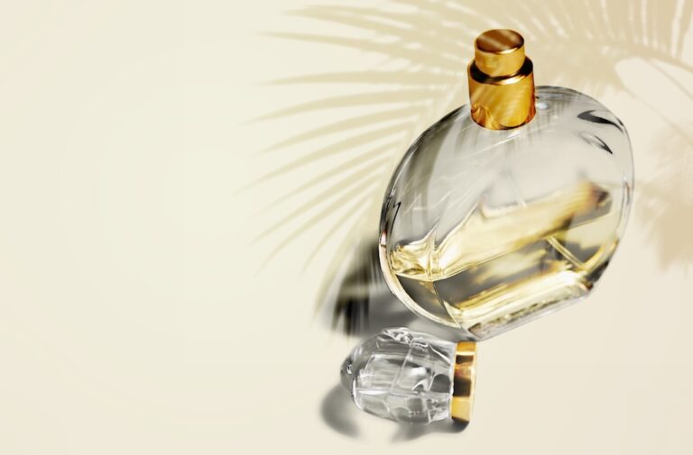 Bottle of perfume with palm leaf shadows.