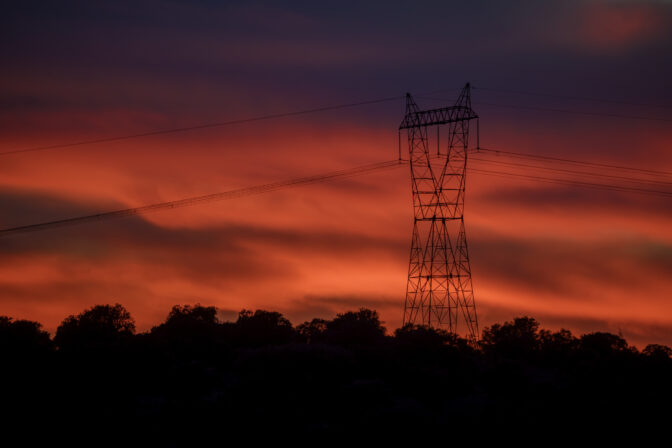 High voltage electricity tower in sunset