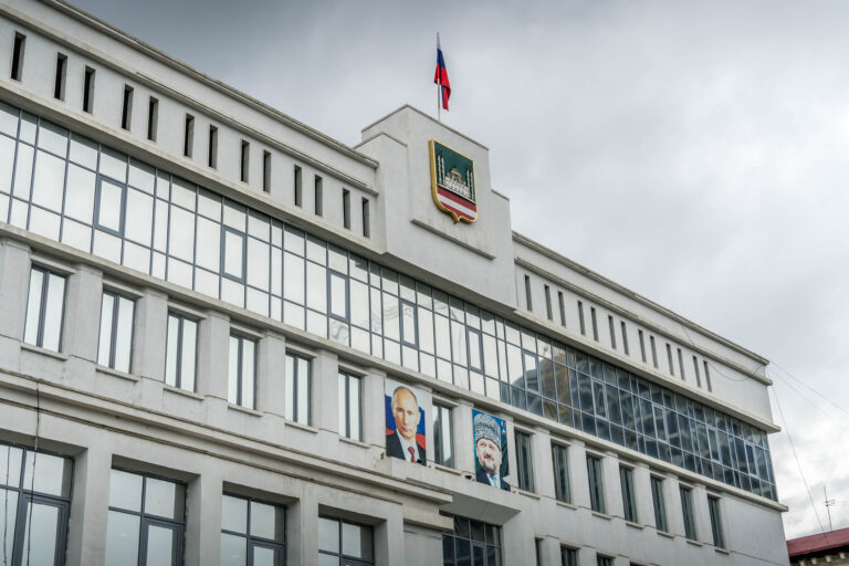 The city administration in Grozny, Republic of Chechnya, with the flag and coat of arms, and portraits of Vladimir Putin and Akhmad Khadzhi Kadyrov.