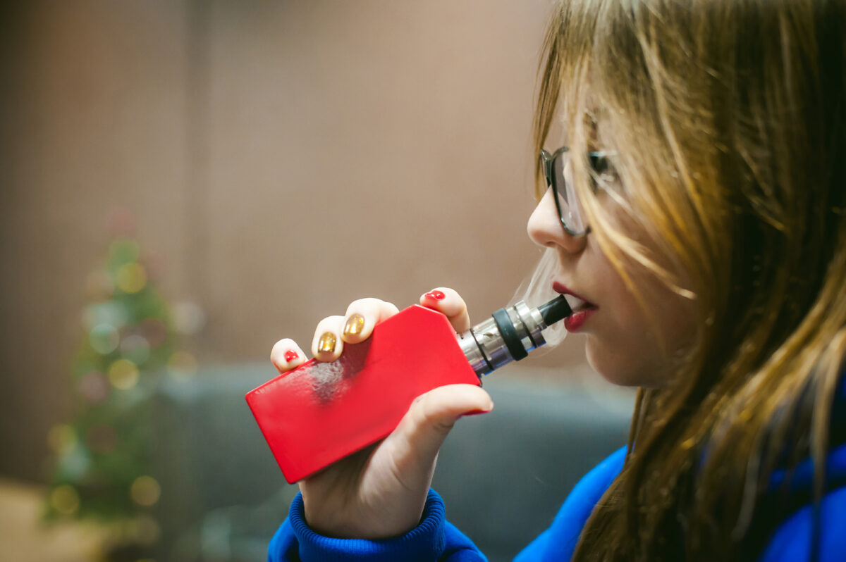 Close Up Of Young Woman Smoking Electronic Cigarette