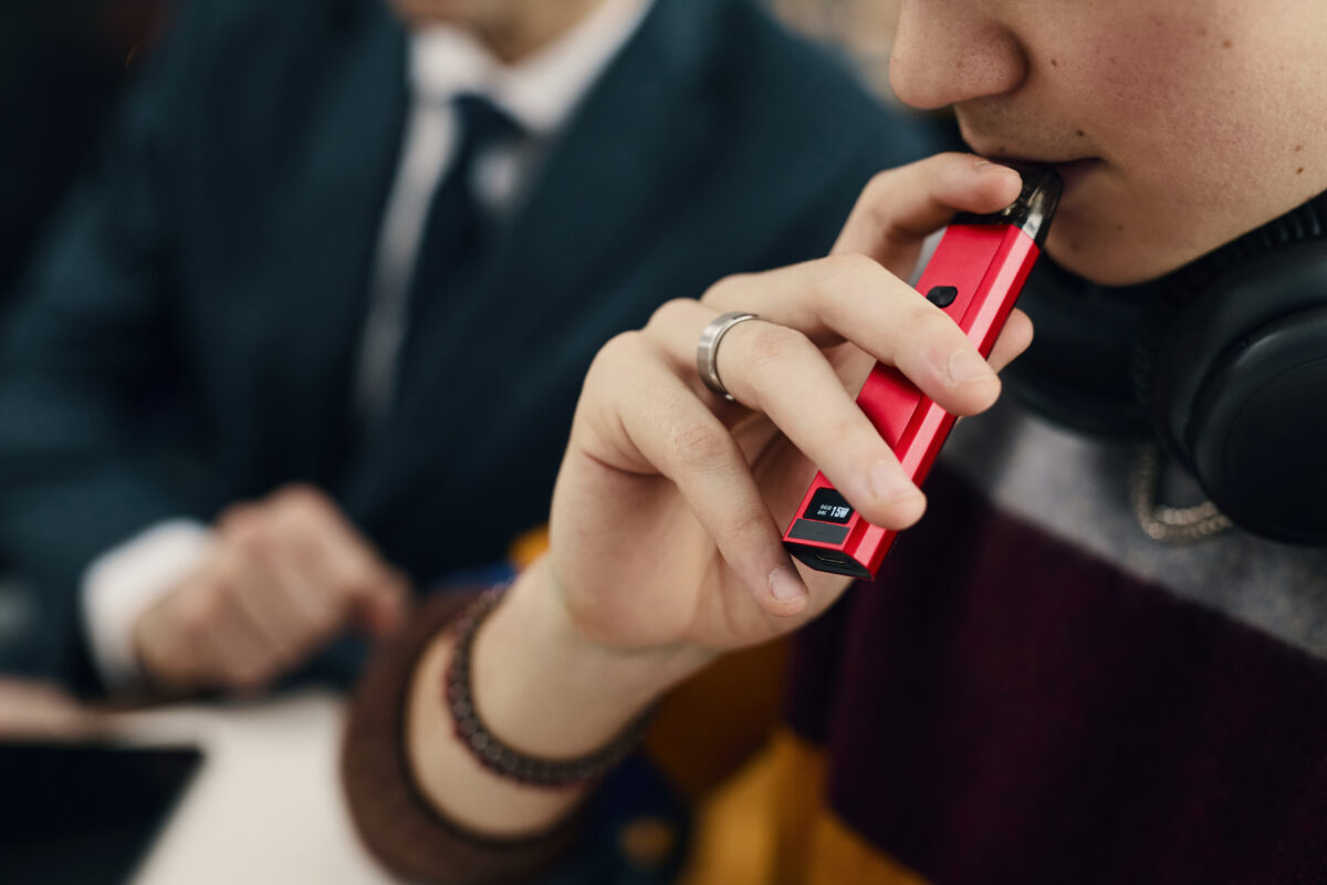 Employee Smoking Electronic Cigarette At Work
