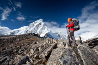 Hiker walks on train in Himalayas
