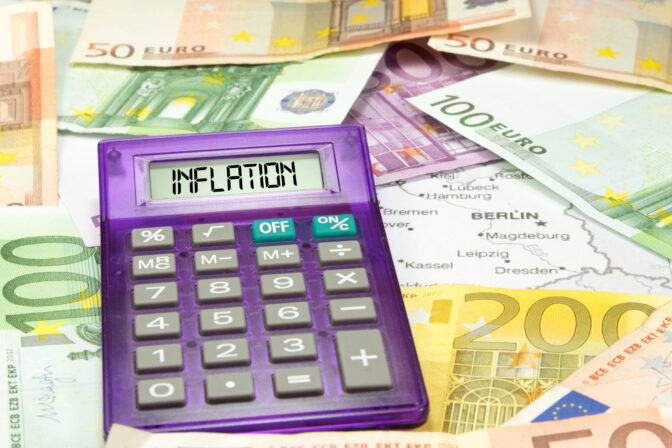Map of Germany, euro banknotes, a calculator and inflation