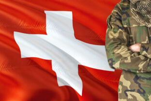 Crossed arms Swiss soldier with national waving flag on background - Switzerland Military theme.