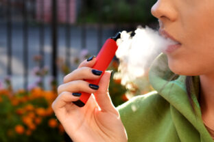 Beautiful brunette smoke electronic cigarette
