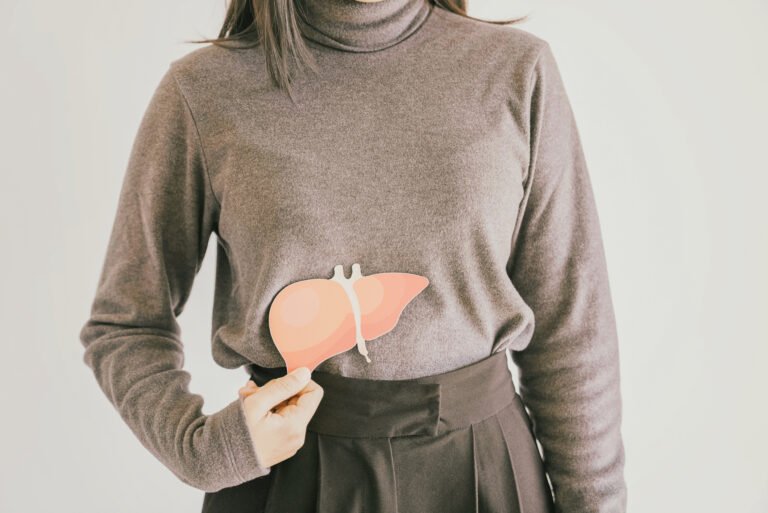 Woman holding liver paper cut, hepatitis vaccination, liver cancer treatment, world hepatitis day