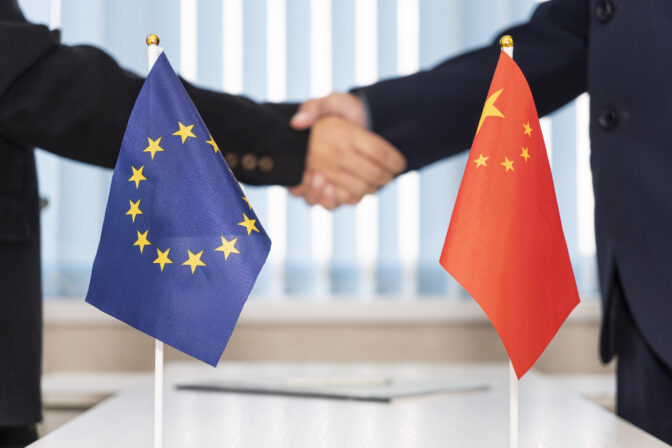 Political flags of European Union and china on table. concept of negotiations, collaboration and cooperation of countries. agreement between governments.