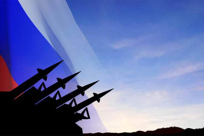 The missiles at the sky at sunset with Russian flag