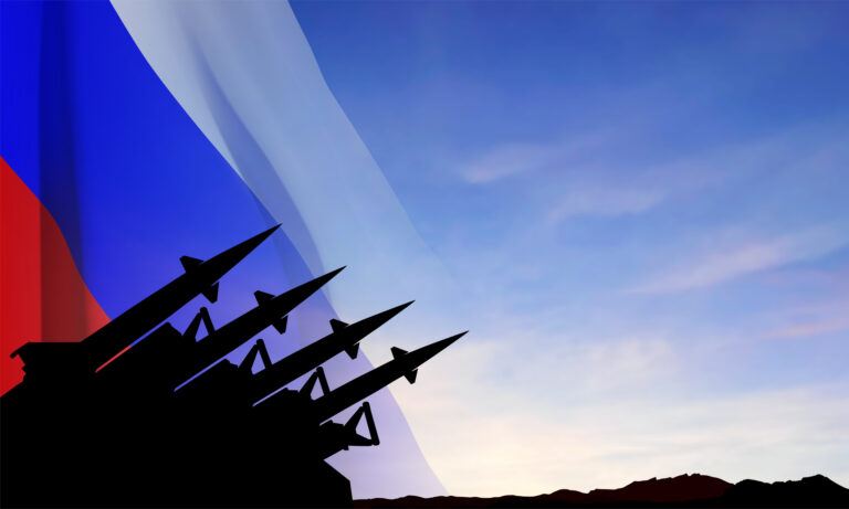 The missiles at the sky at sunset with Russian flag