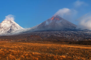 Autumn mountain landscape view at sunrise of eruption active volcano