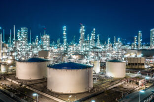 Oil refinery plant from industry zone, Aerial view oil and gas industrial, Refinery factory oil storage tank and pipeline steel at night.