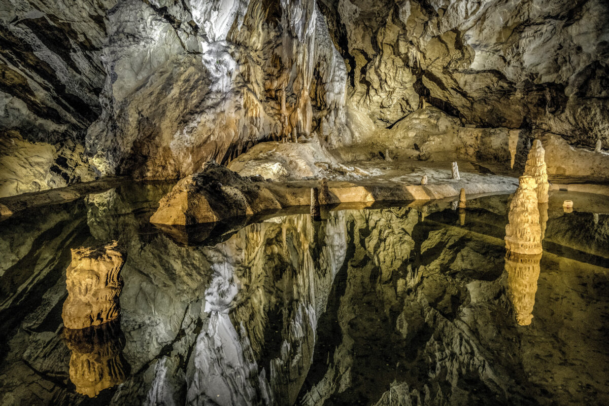 Colorful lake and stalactites and stalagmites in Belianska cave in Slovakia