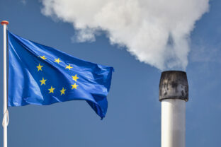 European flag in front of a factory chimney