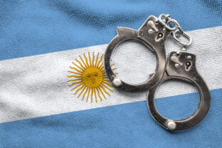 Flag of Argentina and police handcuffs.