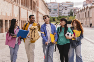 Blind university student walking with friends on campus