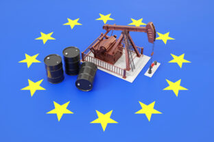 Oil pumpjack and oil barrels on European Union flag