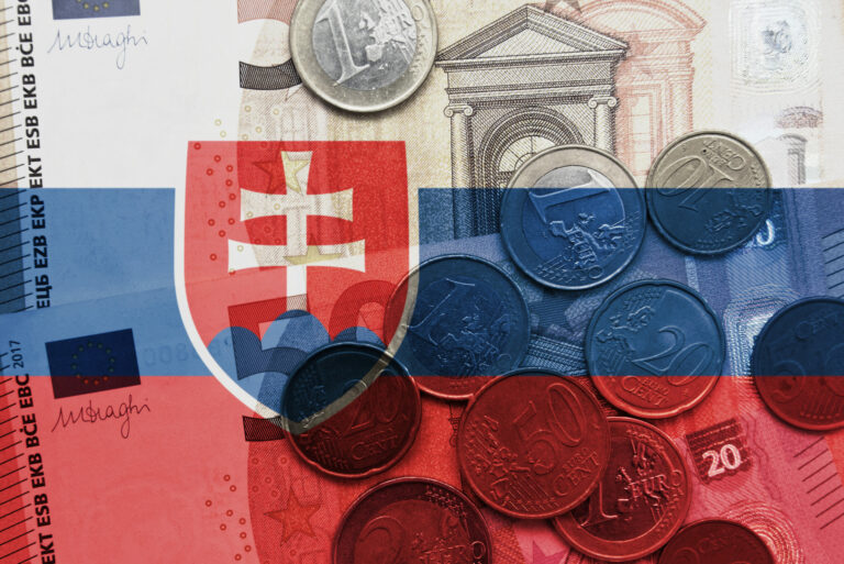 Colourful national flag of slovakia on a euro money banknotes and coins background. finance concept.