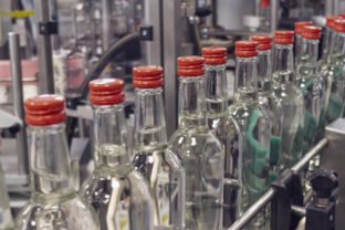 The bottles on the conveyor belt at the plant for bottling of alcoholic beverages, Russian vodka
