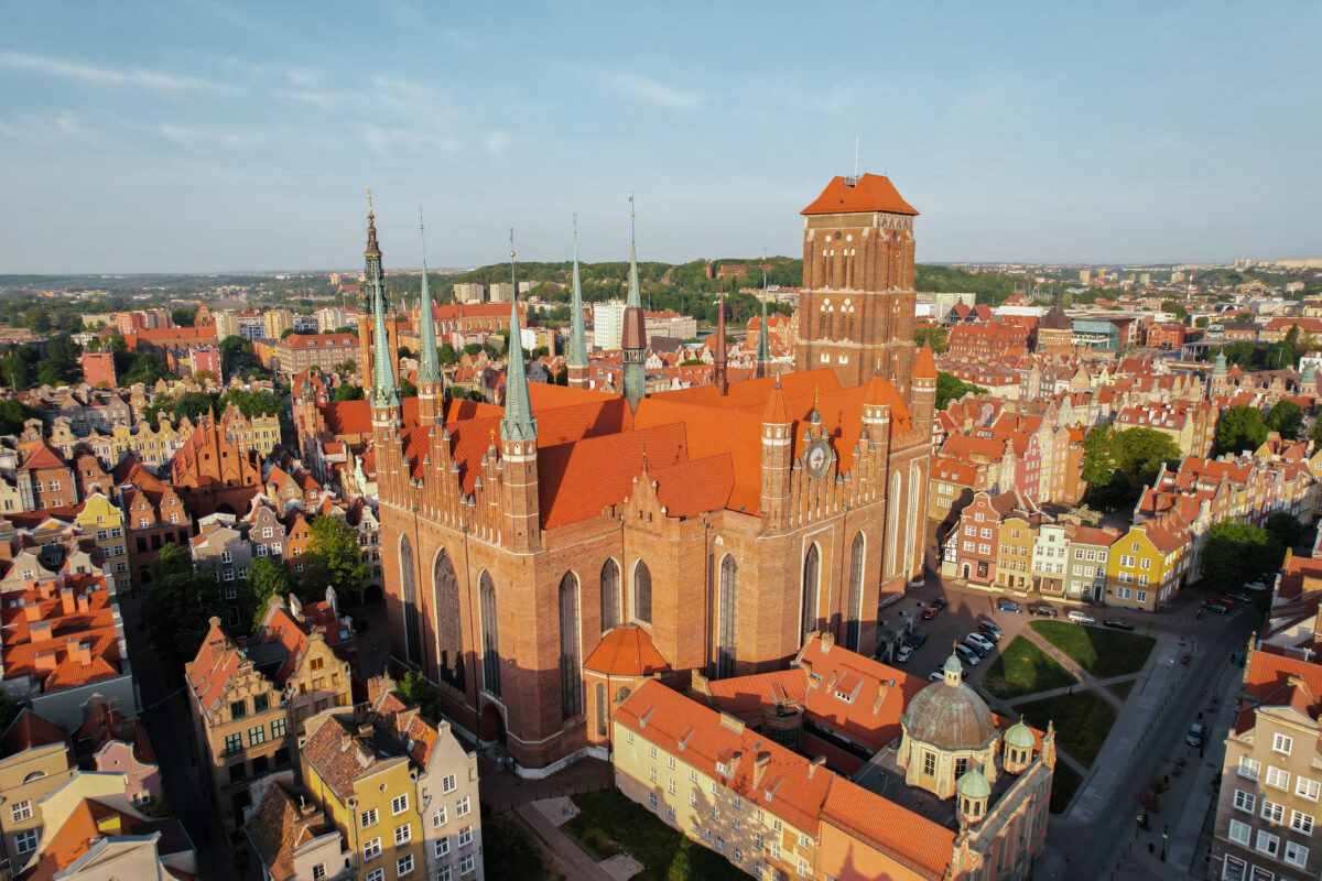 St. Mary&#039;s Basilica Beautiful panoramic architecture of old town in Gdansk, Poland at sunrise. Aerial view drone pov. Landscape cityscape City from Above. Small vintage historical buildings Europe Tourist Attractions travel destination