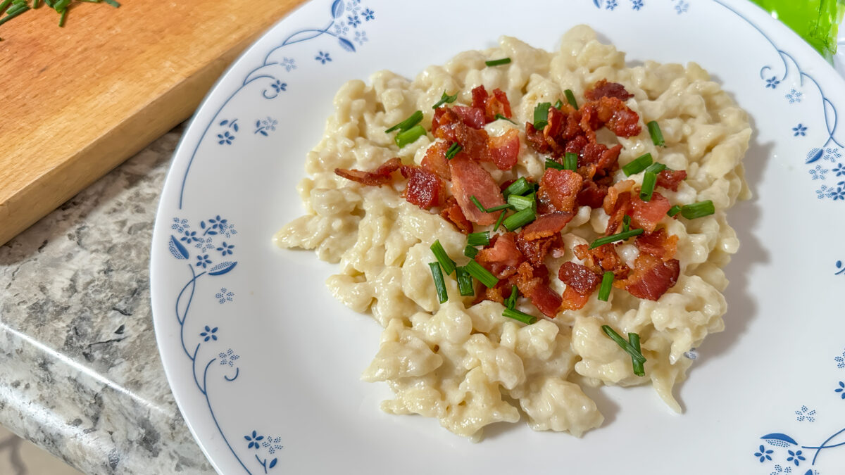 Traditional slovak dish dumplings with sheep cheese or bryndzove halusky, chives and beacon from above