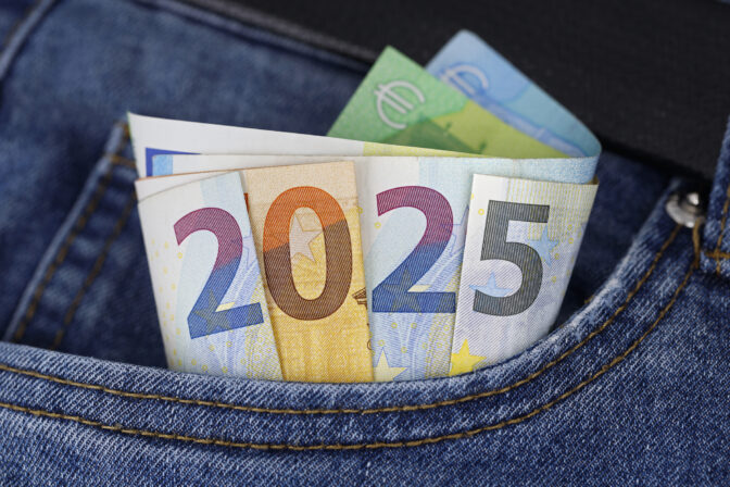 Cash in the trouser pocket shows the year 2025, euro banknotes in blue jeans symbolize wealth or tax changes in the new year in europe