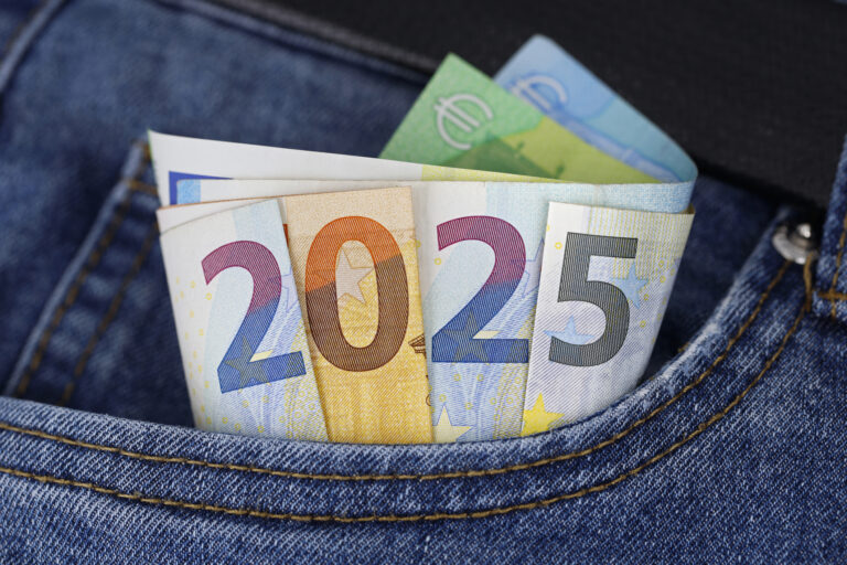 Cash in the trouser pocket shows the year 2025, euro banknotes in blue jeans symbolize wealth or tax changes in the new year in europe