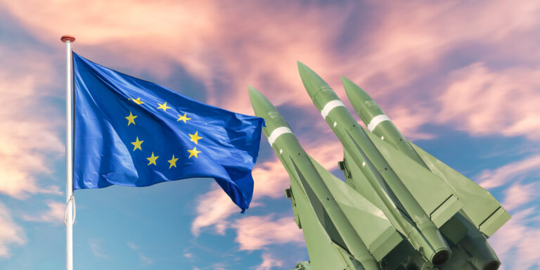 The Europian Union flag in front of tactical missile weapons