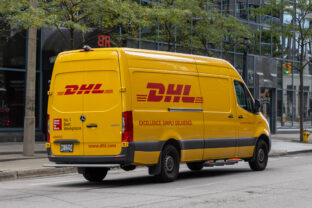 Yellow DHL delivery van on the road