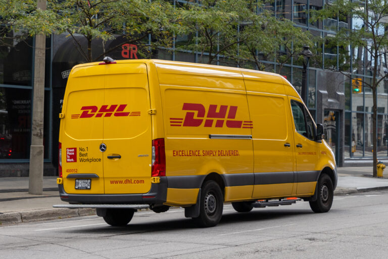 Yellow DHL delivery van on the road
