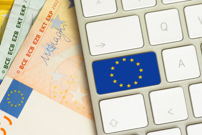 EU flag on computer keyboard and euro money