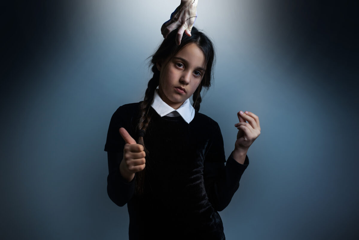 Halloween. A girl in a suit. Holiday. Hallowmas. Wednesday Addams. The Addams Family. Reincarnation. Cosplay. Idea for Halloween. Portrait of a girl.