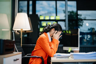Business woman is stressed, bored, and overthinking from working on a tablet