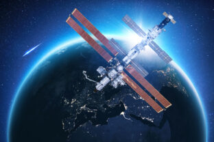 The ISS flies near blue night planet Earth at sunset. Space mission and space exploration. Communications and technologies in Earth orbit